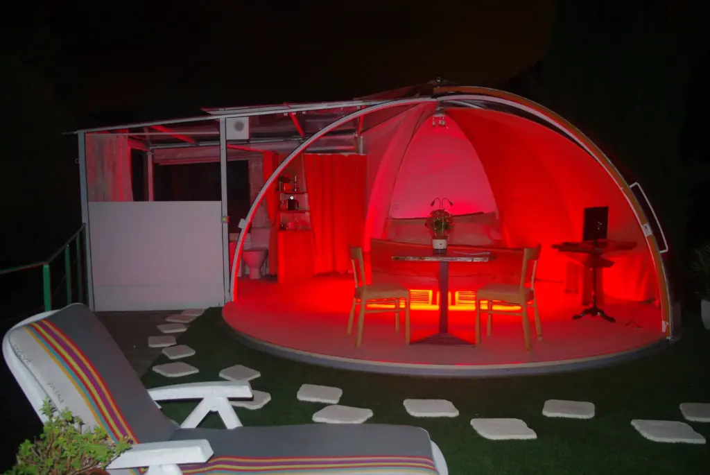 Au Bois Fleuri : bulle éclairée en rouge à la nuit tombée
